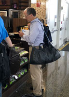 A man carrying an oversized purse